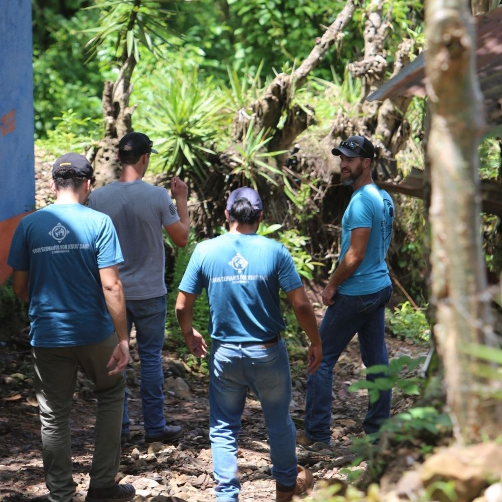 VBI_ChurchPartners_Square_2025 group of people in blue shirts walking into the jungle