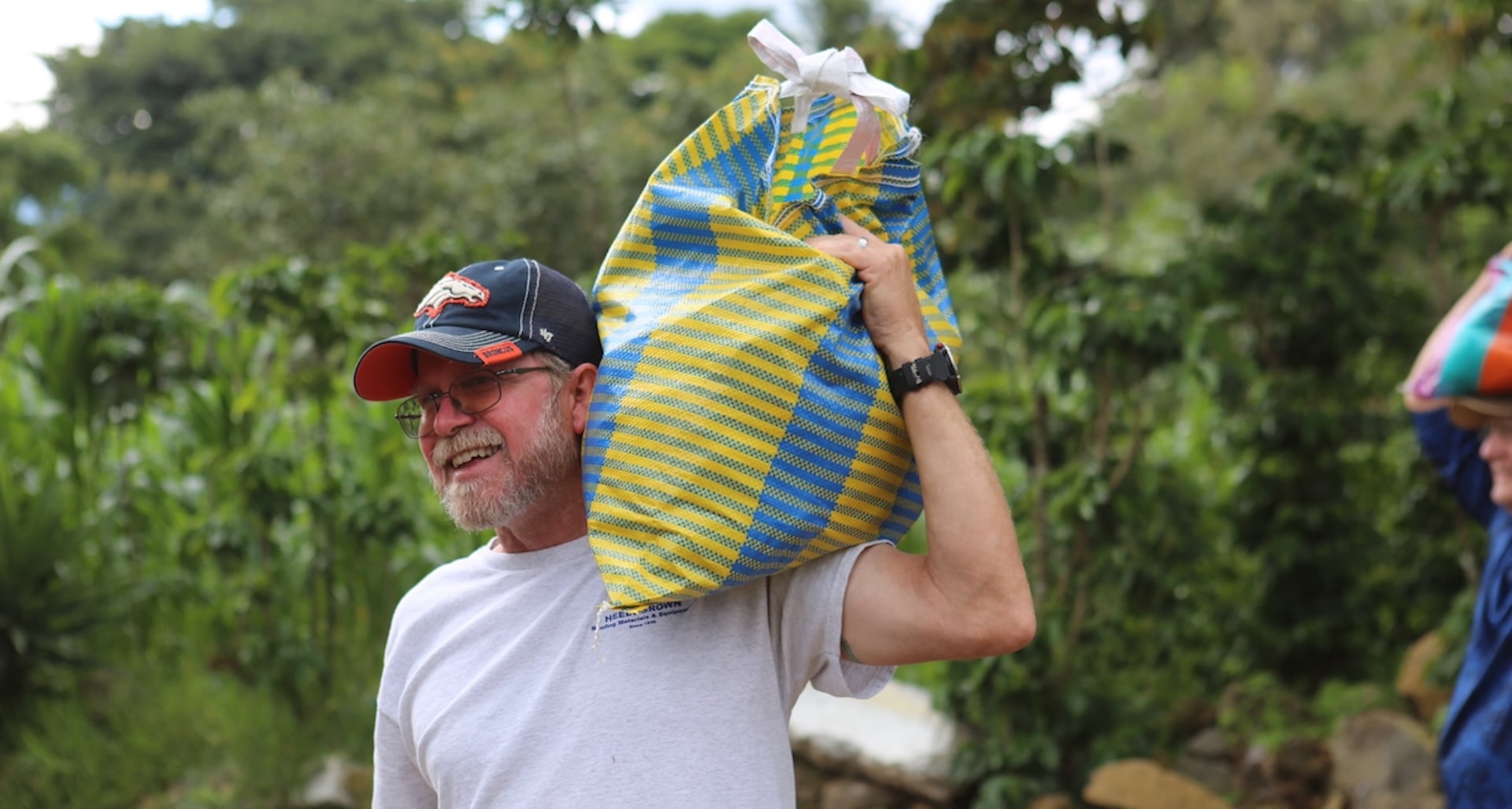 photo of a man carrying a bag on his shoulder